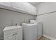 The laundry room has a utility sink, white cabinets and a newer washer and dryer at 116 Arlen Park Pl, Holly Springs, NC 27540