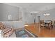 Open-concept living space with hardwood flooring, a neutral color palette, and seamless flow into dining and staircase at 116 Arlen Park Pl, Holly Springs, NC 27540