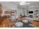 A well-designed, open-concept living space featuring a fireplace, high ceilings, and views of the kitchen at 116 Arlen Park Pl, Holly Springs, NC 27540