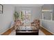 Cozy living room featuring plush armchairs, a large window offering natural light and hardwood floors with an area rug at 116 Arlen Park Pl, Holly Springs, NC 27540