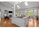 Open concept home boasting multiple skylights, a fireplace, island with cooktop, and abundant seating and dining spaces at 116 Arlen Park Pl, Holly Springs, NC 27540