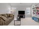This living room features a sofa, a television, and built-in shelves on the wall at 116 Arlen Park Pl, Holly Springs, NC 27540