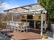 A covered outdoor bar area includes seating for six and a built-in TV for entertaining at 116 Arlen Park Pl, Holly Springs, NC 27540