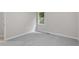 Neutral bedroom featuring gray carpet, window, and freshly painted walls at 1209 Freeman Dr, Sanford, NC 27330