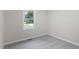 Cozy bedroom with gray carpeting and a large window overlooking the backyard at 1209 Freeman Dr, Sanford, NC 27330
