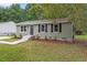 Charming single-story home features updated landscaping and stylish exterior with newly painted door and shutters at 1209 Freeman Dr, Sanford, NC 27330
