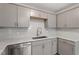 Modern kitchen features stainless steel appliances, gray cabinets, subway tile backsplash, and marble countertops at 1209 Freeman Dr, Sanford, NC 27330