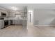 Open-concept layout with a combined kitchen and living room area with a door to the hallway at 1209 Freeman Dr, Sanford, NC 27330