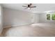 Spacious living room features hardwood floors, a ceiling fan, and a view of the backyard from the windows at 1209 Freeman Dr, Sanford, NC 27330