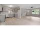 Bright living room features hardwood floors, a ceiling fan, and a front door with windows to the backyard at 1209 Freeman Dr, Sanford, NC 27330