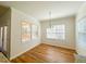 Well-lit dining area with charming chandelier and windows providing natural light at 1220 E Middleton Dr, Creedmoor, NC 27522