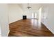Open living room with vaulted ceiling, fireplace, wood floors, and access to the backyard patio at 1220 E Middleton Dr, Creedmoor, NC 27522