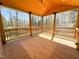 Open screened porch with wood flooring and railing, offering a serene outdoor space at 1220 E Middleton Dr, Creedmoor, NC 27522