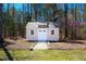 Backyard shed with double doors and windows, perfect for storage or hobbies at 1220 E Middleton Dr, Creedmoor, NC 27522