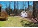 A backyard shed with a white door and windows provides convenient storage at 1220 E Middleton Dr, Creedmoor, NC 27522