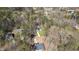 An aerial view reveals the home nestled within a wooded community and long driveway at 133 Mohawk Dr, Louisburg, NC 27549