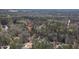 An aerial view shows the property and surrounding wooded area near a body of water at 133 Mohawk Dr, Louisburg, NC 27549