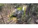 Aerial view of a home nestled among trees with a long driveway and grassy lawn at 133 Mohawk Dr, Louisburg, NC 27549
