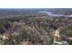 Aerial view of the property in a wooded neighborhood close to a lake at 133 Mohawk Dr, Louisburg, NC 27549
