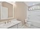 Bathroom featuring a shower-tub combo with a single sink vanity with framed mirror and custom fixtures at 133 Mohawk Dr, Louisburg, NC 27549