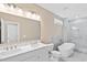 Bright bathroom featuring dual sinks, a soaking tub, and a walk-in shower at 133 Mohawk Dr, Louisburg, NC 27549