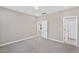 Neutral bedroom with carpet flooring, ceiling fan, and white doors at 133 Mohawk Dr, Louisburg, NC 27549