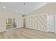 Bright dining area featuring wood floors, modern lighting fixture, and decorative wall paneling at 133 Mohawk Dr, Louisburg, NC 27549