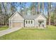 Charming home featuring a neatly kept lawn, attached garage, and beautiful, neutral-toned siding at 133 Mohawk Dr, Louisburg, NC 27549