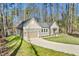 A shot of a well-maintained, modern home with an attached garage and a long driveway at 133 Mohawk Dr, Louisburg, NC 27549