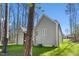 The home's exterior shows the landscaped backyard with partial view of the screened porch at 133 Mohawk Dr, Louisburg, NC 27549