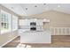 Eat-in kitchen featuring white cabinets, granite counters, stainless appliances, and wood-look flooring at 133 Mohawk Dr, Louisburg, NC 27549