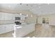 Well-lit, modern kitchen featuring stainless appliances, granite countertops, and wood-look flooring at 133 Mohawk Dr, Louisburg, NC 27549