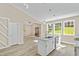Modern eat-in kitchen featuring stainless appliances, granite countertops, and wood-look flooring at 133 Mohawk Dr, Louisburg, NC 27549