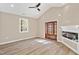 Bright and open living space featuring a fireplace, statement doors, and wood-look flooring at 133 Mohawk Dr, Louisburg, NC 27549