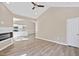 Bright living room featuring an electric fireplace, ceiling fan, and wood-look flooring at 133 Mohawk Dr, Louisburg, NC 27549