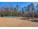 A fenced playground area next to the pickleball court with a colorful playset and swings, perfect for ' outdoor fun at 133 Mohawk Dr, Louisburg, NC 27549