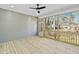 An open porch with wooden floors and ceiling fan provides tranquil outdoor living space at 133 Mohawk Dr, Louisburg, NC 27549