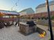 Evening shot of backyard featuring outdoor kitchen and patio with string lights creating an inviting ambiance at 1403 Copper Cir, Mebane, NC 27302