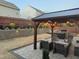 Inviting backyard featuring a pergola with string lights and built-in grill, designed for outdoor gatherings at 1403 Copper Cir, Mebane, NC 27302