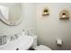 Bright half bathroom featuring stylish decor, oval mirror, and crisp, neutral walls at 1403 Copper Cir, Mebane, NC 27302