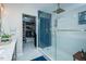 Modern bathroom with blue tiled shower and a walk-in closet for convenient storage at 1403 Copper Cir, Mebane, NC 27302