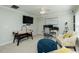 A versatile room that may serve as an office with a desk, air hockey table, and comfortable seating at 1403 Copper Cir, Mebane, NC 27302
