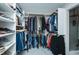 Large walk-in closet featuring extensive shelving, hanging space, and luxurious tiled floors at 1403 Copper Cir, Mebane, NC 27302