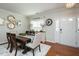 Inviting dining room with hardwood floors, a wooden table, and a stylish rug at 1403 Copper Cir, Mebane, NC 27302