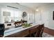 Elegant dining area featuring hardwood floors, a wooden table, and modern lighting at 1403 Copper Cir, Mebane, NC 27302