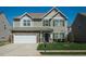 Charming two-story home with stone accents, a two-car garage, and well-maintained landscaping at 1403 Copper Cir, Mebane, NC 27302