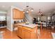 Open kitchen with a granite-topped island, wooden cabinets, and seamless flow to the dining area at 1403 Copper Cir, Mebane, NC 27302