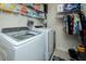 Practical laundry area with washer, dryer, storage shelves, and hanging rod for convenience at 1403 Copper Cir, Mebane, NC 27302