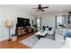 Comfortable living room with hardwood floors, a plush sectional sofa, and modern entertainment setup at 1403 Copper Cir, Mebane, NC 27302