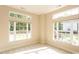 Sunlit bedroom with carpet floors and large windows offering serene views of the surrounding landscape at 1503 Orchard Villas Ave, Apex, NC 27502